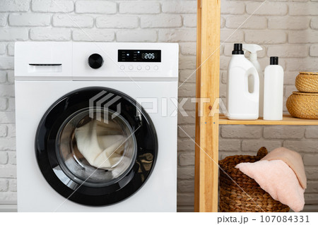 Modern white washing machine close up photo 107084331