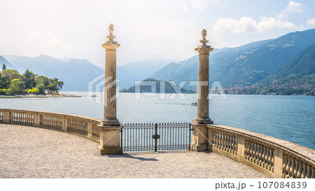 Ornamental gate with roman columns to Como Lake, Italian: Lago di Como, Bellagio, Lombardy, Italy 107084839