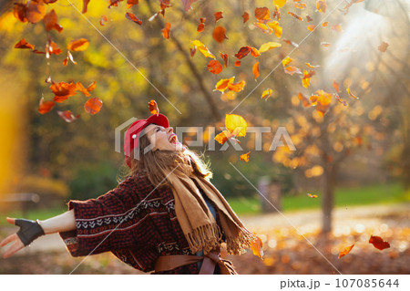 happy trendy 40 years old woman in red hat rejoicing happy trendy 40 years old woman in red hat rejoicing 107085644