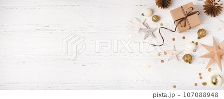 Festive Christmas background with gift box and Christmas decorations 107088948