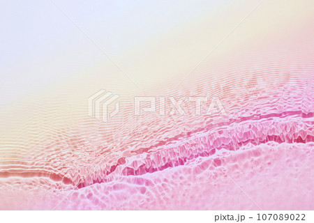 The texture of water on a pink background. The texture of water on a pink background. 107089022
