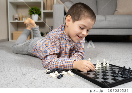 Little boy playing chess. Board games for children Little boy playing chess. Board games for children 107089585
