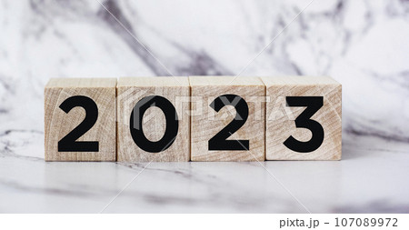 On a cube made of wooden blocks 2023 on a beautiful background. Preparing a new year and launching  107089972