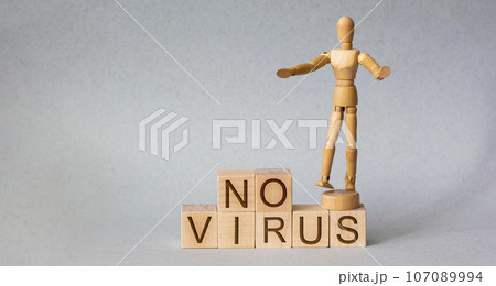 Wooden man with wooden block written no virus Wooden man with wooden block written no virus 107089994