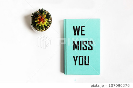 Tex We miss you on green notepad and white background 107090376
