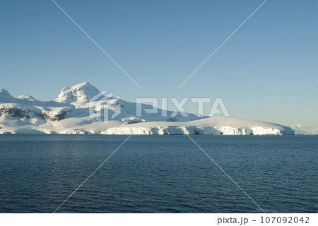 Lemaire strait coastal landscape, mountains and icebergs, Antarctic Peninsula, Antartica. 107092042