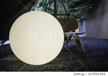 A bright glowing matte white burning round light bulb 107093368