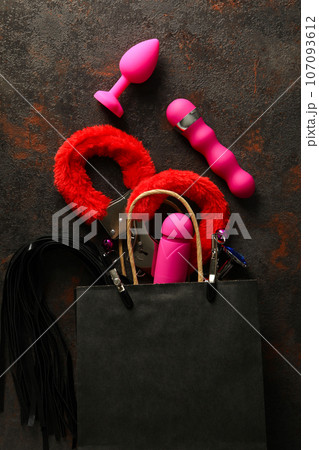 A collection of sex toys on a dark background. - Stock Photo [107093612]