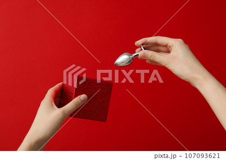 Metal anal plug on a red background. Metal anal plug on a red background. 107093621