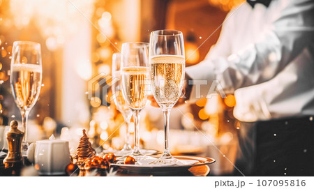 Elegant glasses of champagne served by waiter at wedding celebration or celebration, dinner, party. Restaurant service Elegant glasses of champagne served by waiter at wedding celebration or celebration, dinner, party. Restaurant service 107095816