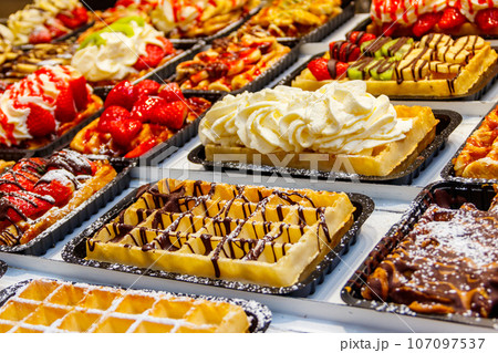 Belgian waffles with colorful sweet toppings and fruits for sale in Brussels, Belgium 107097537