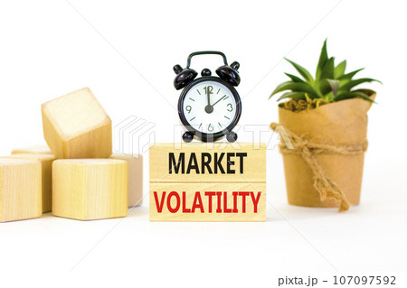 Market volatility symbol. Concept words Market volatility on beautiful wooden blocks. Beautiful white table white background. Black alarm clock. Business market volatility concept. Copy space. Market volatility symbol. Concept words Market volatility on beautiful wooden blocks. Beautiful white table white background. Black alarm clock. Business market volatility concept. Copy space. 107097592