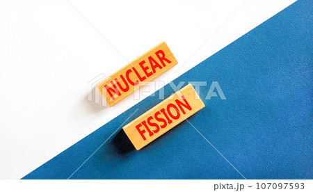 Nuclear fission symbol. Concept words Nuclear fission on beautiful wooden blocks. Beautiful white and blue background. Business science nuclear fission concept. Copy space. Nuclear fission symbol. Concept words Nuclear fission on beautiful wooden blocks. Beautiful white and blue background. Business science nuclear fission concept. Copy space. 107097593