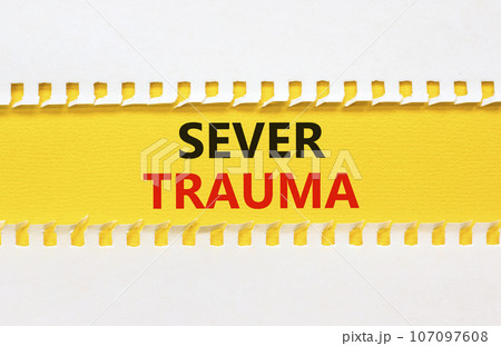 Sever trauma symbol. Concept words Sever trauma on yellow paper. Beautiful white background. Psychological and sever trauma concept. Copy space. 107097608