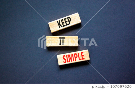 Keep it simple symbol. Concept word Keep it simple on beautiful wooden block. Beautiful black table black background. Business motivational keep it simple concept. Copy space. 107097620