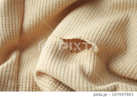 hole in the clothes. Close-up. hole in the clothes. Close-up. 107097863