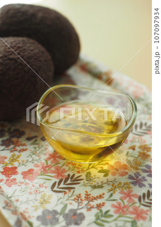 oil and slice of avocado on wooden table oil and slice of avocado on wooden table 107097934