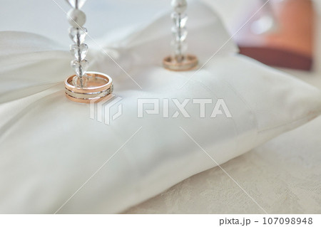 White pillow for wedding rings in a heart 107098948