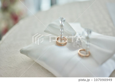White pillow for wedding rings in a heart 107098949