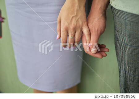 Young married couple holding hands, ceremony wedding day 107098950