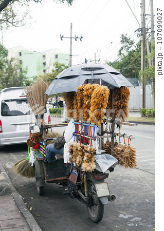 Man sells Feather dusters, Bangkok, Thailand Man sells Feather dusters, Bangkok, Thailand 107099027