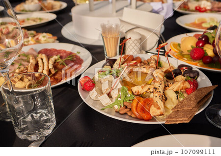 large lunch set of three courses soup, second course and salad, Top view of a three course set menu served on wooden table, business lunch set made of three meals 107099111