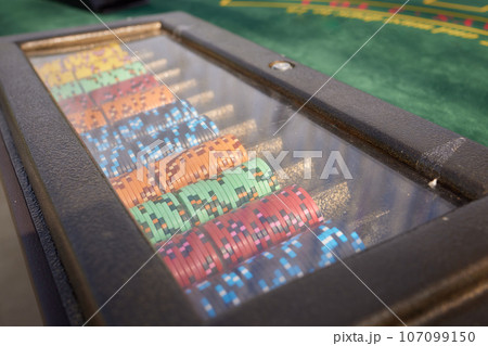 Casino. Poker. Game pieces and dice are on the table. Game chips for betting in gambling. Dice. Poker chips. Casino. Poker. Game pieces and dice are on the table. Game chips for betting in gambling. Dice. Poker chips. 107099150
