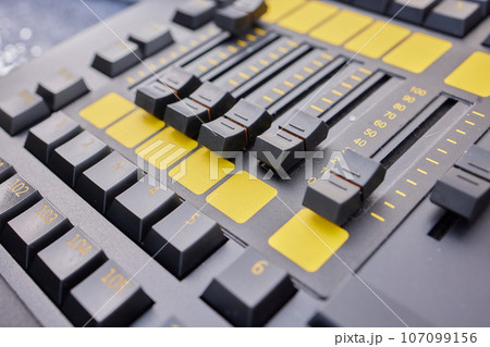 Man hands of sound engineer adjusting audio mixing console. 107099156