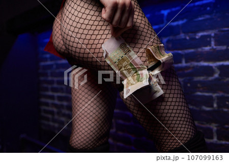 Young worker with earned money in brothel, closeup. 107099163