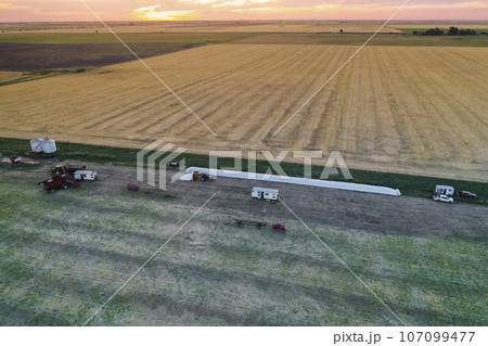 Silo bag work in pampas countryside, grain storage in La Pampa, Argentina Silo bag work in pampas countryside, grain storage in La Pampa, Argentina 107099477