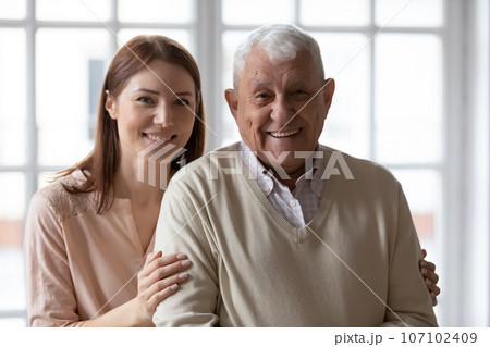 Portrait of happy elderly father and adult daughter hugging Portrait of happy elderly father and adult daughter hugging 107102409