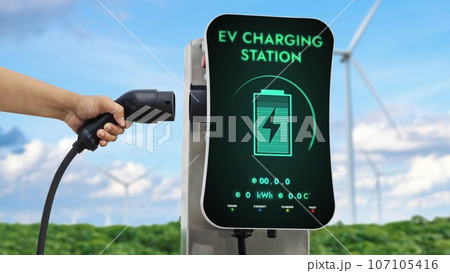 EV charger from EV car charging station at wind turbine. Persuse 107105416