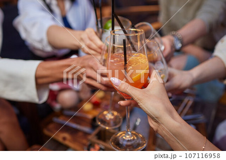 Clinking glasses with alcohol and toasting, party. Clinking glasses with alcohol and toasting, party. 107116958