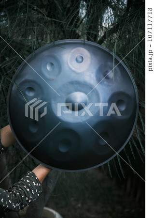 hang handpan in a woman hands hang handpan in a woman hands 107117718
