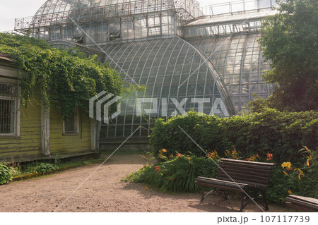 corner of an old botanical garden with a huge vintage greenhouse in the background corner of an old botanical garden with a huge vintage greenhouse in the background 107117739