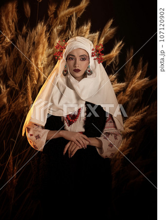 Woman as motanka . Traditional costume. Symbolism, ancient magic, force of nature, cosplay Woman as motanka . Traditional costume. Symbolism, ancient magic, force of nature, cosplay 107120902