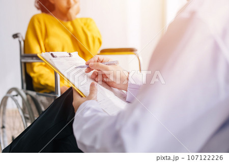 Psychiatrist doctor collect data talk with patient on wheelchair for mental care health problems check followup in hospital clinic Psychiatrist doctor collect data talk with patient on wheelchair for mental care health problems check followup in hospital clinic 107122226