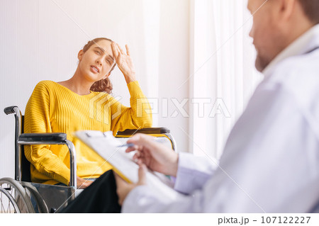 Psychiatrist doctor collect data talk with patient on wheelchair for mental care health problems check followup in hospital clinic Psychiatrist doctor collect data talk with patient on wheelchair for mental care health problems check followup in hospital clinic 107122227