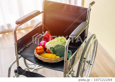 Wheelchair with mix fruit and vegetable for eating good nutrition foods for support strong healthy and health care concept 107122269