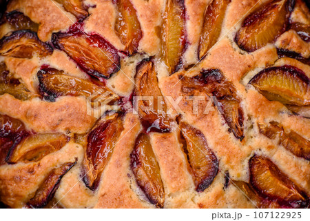 Delicious sweet aromatic homemade pie with ripe plums Delicious sweet aromatic homemade pie with ripe plums 107122925