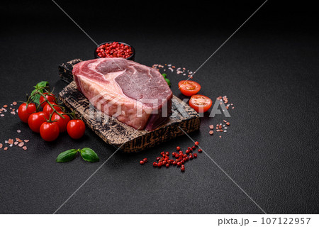 Fresh raw beef striploin steak with salt, spices and herbs Fresh raw beef striploin steak with salt, spices and herbs 107122957