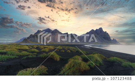 Stokksnes cape in Iceland during sunrise. Vestrahorn mountains. Amazing Iceland nature seascape. 107123488