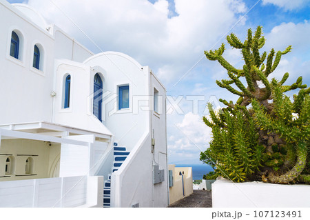 White architecture on Santorini island, Greece. Beautiful landscape, cloudy blue sky. 107123491
