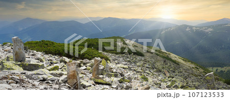 Sunset in green summer mountains. Vibrant photo wallpaper. The tranquil beauty of the earth concept. Sunset in green summer mountains. Vibrant photo wallpaper. The tranquil beauty of the earth concept. 107123533