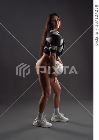 Alluring naked woman in hockey player uniform 107124239