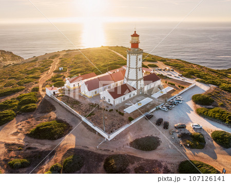 Aerial drone view of lighthouse on Cabo Espichel cape Espichel on Atlantic ocean at sunset. Sesimbra, Portugal 107126141