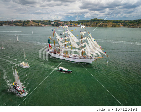 Aerial drone view of tall ships with sails sailing in Tagus river towards the Atlantic ocean in Lisbon, Portugal 107126191