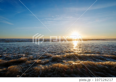 Atlantic ocean sunset with surging waves at Fonte da Telha beach, Costa da Caparica, Portugal Atlantic ocean sunset with surging waves at Fonte da Telha beach, Costa da Caparica, Portugal 107126217