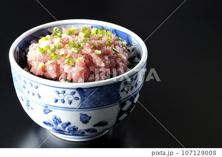 小葱が沢山乗っているマグロのたたき丼を黒背景で撮影 107129008
