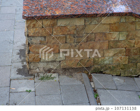 Sand stone wall surface, background of decorate. Broken tile wall 107131138